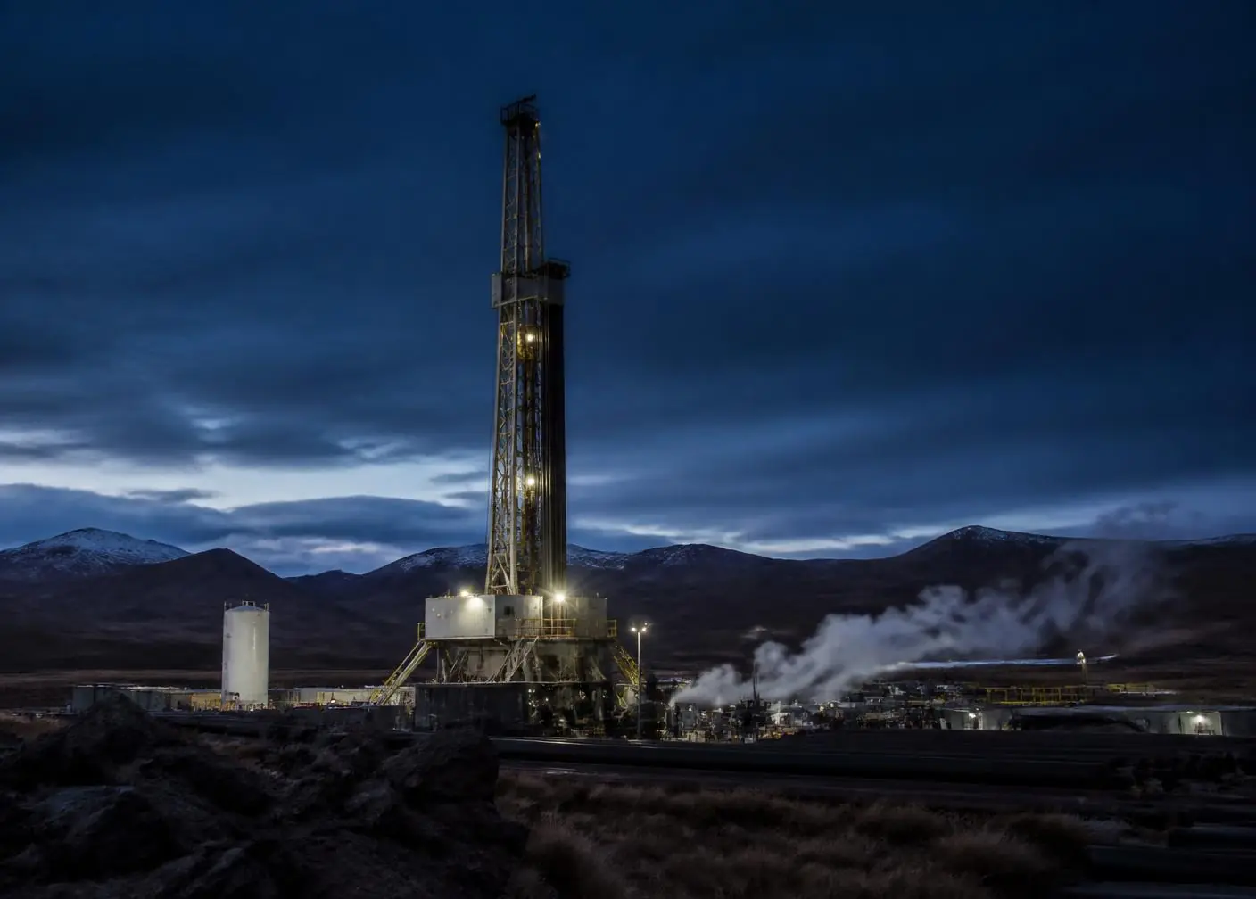 Geothermal exploration drilling rig on a high Andean plateau at dusk